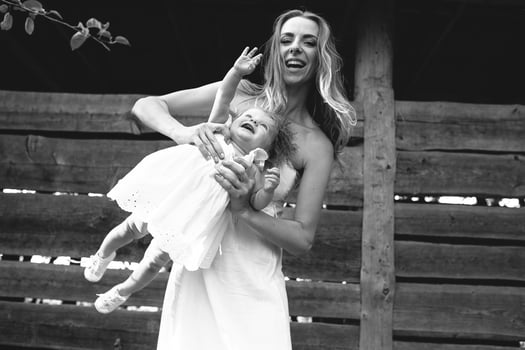 mother playing with his little daughter photo