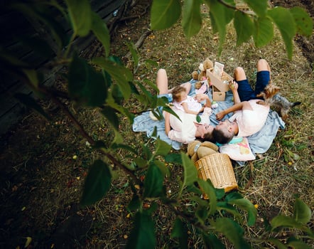 Happy family on lawn in the park photo