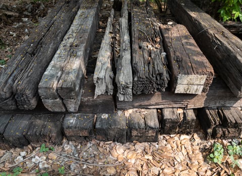 The old wooden railroad sleeper piled up beside the railway station. photo