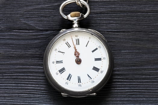 two minutes to twelve on vintage watch on black photo
