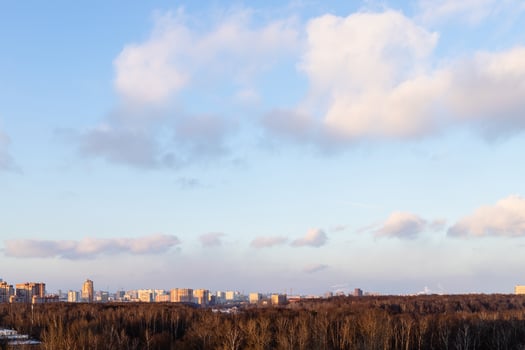 sunset sky with clouds over city park and houses photo