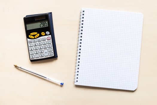 squared paper, pen and financial calculator photo