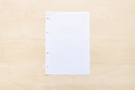 blank sheet of squared paper on light board photo