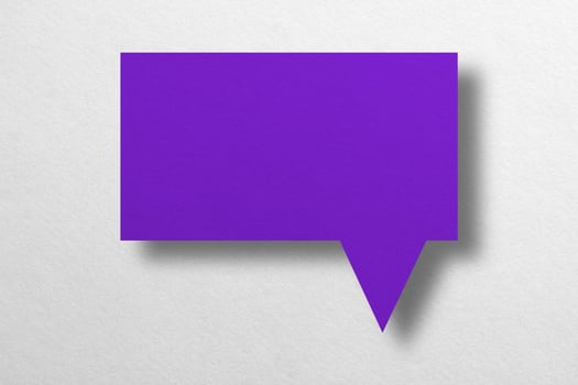 purple paper cut speech balloon shape isolated on white background photo