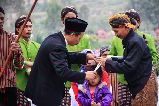 Dieng, Indonesia - August 1, 2015. Dieng Culture Festival, Tourists follow the dreadlocks procession during the Dieng Culture Festival event at Dieng, Banjarnegara district, Central Java photo