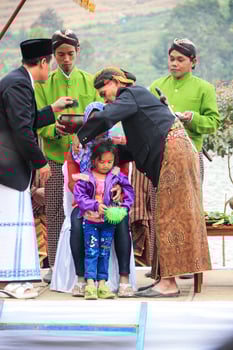 Dieng, Indonesia - August 1, 2015. Dieng Culture Festival, Tourists follow the dreadlocks procession during the Dieng Culture Festival event at Dieng, Banjarnegara district, Central Java photo