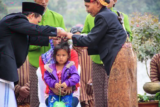 Dieng, Indonesia - August 1, 2015. Dieng Culture Festival, Tourists follow the dreadlocks procession during the Dieng Culture Festival event at Dieng, Banjarnegara district, Central Java photo
