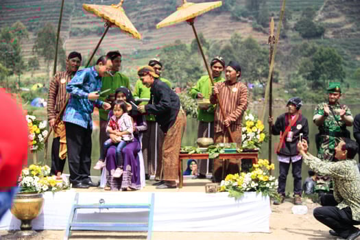 Dieng, Indonesia - August 1, 2015. Dieng Culture Festival, Tourists follow the dreadlocks procession during the Dieng Culture Festival event at Dieng, Banjarnegara district, Central Java photo