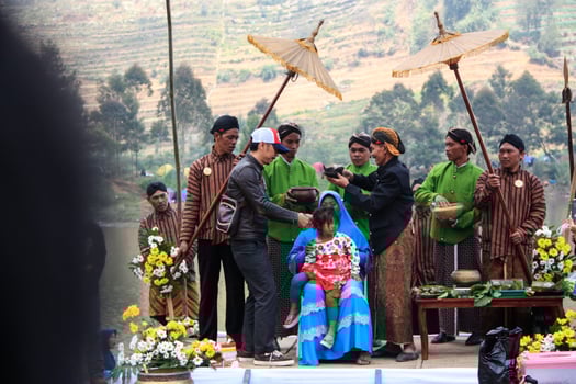 Dieng, Indonesia - August 1, 2015. Dieng Culture Festival, Tourists follow the dreadlocks procession during the Dieng Culture Festival event at Dieng, Banjarnegara district, Central Java photo