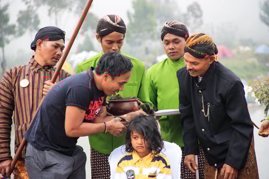 Dieng, Indonesia - August 1, 2015. Dieng Culture Festival, Tourists follow the dreadlocks procession during the Dieng Culture Festival event at Dieng, Banjarnegara district, Central Java photo