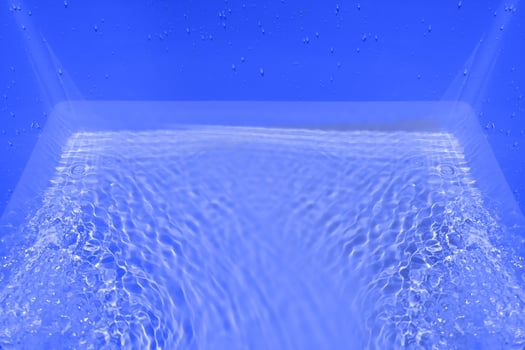 Defocus blurred transparent blue colored clear calm water surface texture with splashes and bubble. Trendy abstract nature background. Water wave in sunlight with copy space. Blue watercolor shining. photo