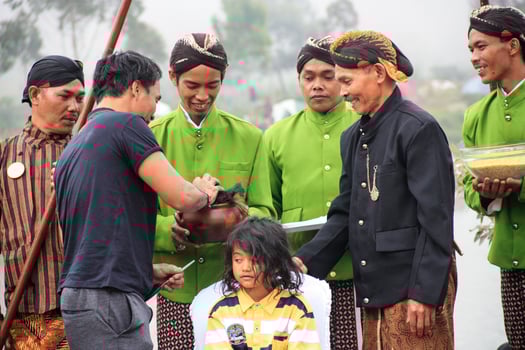 Dieng, Indonesia - August 1, 2015. Dieng Culture Festival, Tourists follow the dreadlocks procession during the Dieng Culture Festival event at Dieng, Banjarnegara district, Central Java photo