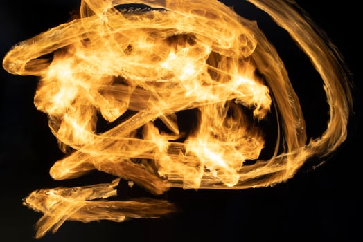 Flames on long hatchet. Traces of fire in dark. photo