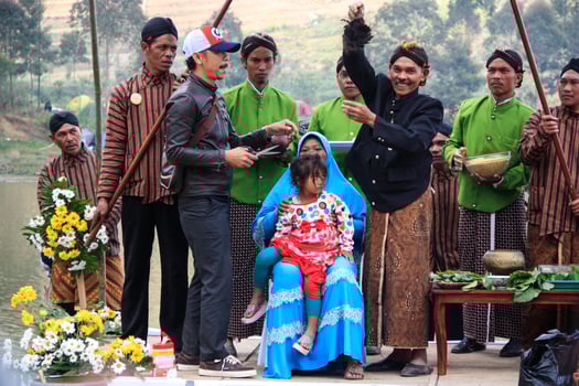 Dieng, Indonesia - August 1, 2015. Dieng Culture Festival, Tourists follow the dreadlocks procession during the Dieng Culture Festival event at Dieng, Banjarnegara district, Central Java photo