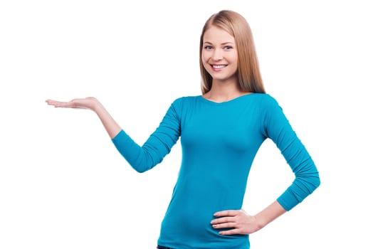 Beautiful confidence. Beautiful young women holding copy space and looking at camera while standing against white background. photo