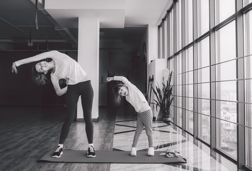 Two girls of different ages makeing yoga photo
