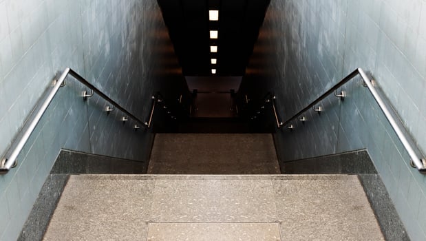Looking down passageway stairs to subway station photo