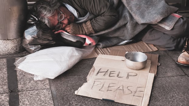 Homeless man sleeping on outdoor floor. photo