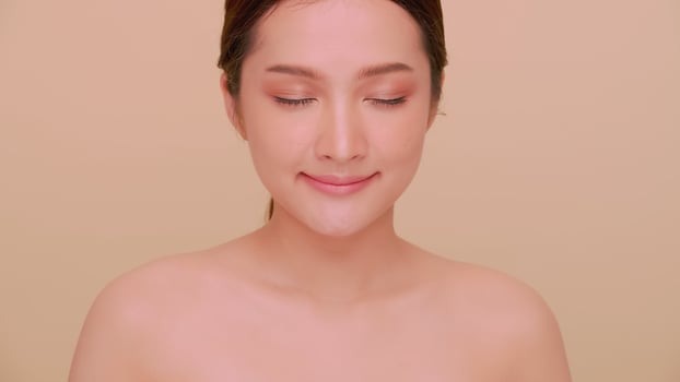 Beautiful face of Asian young woman with natural skin. Portrait of attractive girl with soft makeup and perfectly beautiful skin. photo