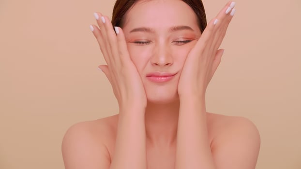 A young woman massaging her face. Portrait of attractive girl with soft makeup and perfectly beautiful skin. photo