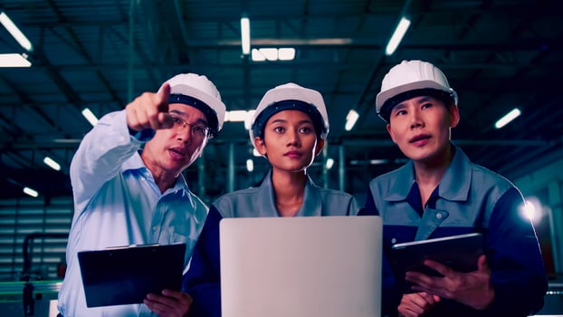 A team of engineers is explaining remote machine control to industrial owners. photo
