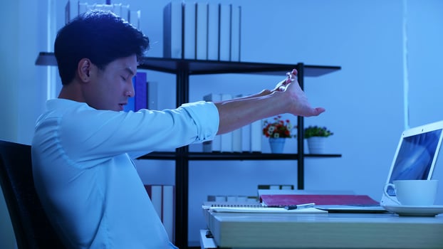 Office man sitting and working pain, He aches the body. And try to stretch the body, Over work at night in office photo