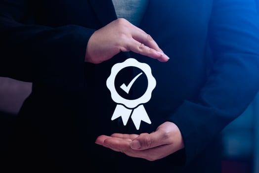business woman's hand shows a symbol of quality assurance or certifying excellent manufacturing standards. ISO certification and standardization concepts. warranty, standards photo