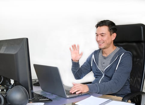 Man in casual outfit working from home with a laptop in the living room photo