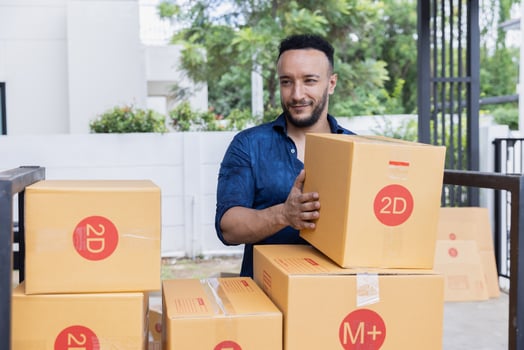New home or property buying concept. Closeup of man packing cardboard box. photo