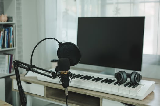 Home music studio condenser studio microphone, piano and white headphone for mixing production song. Home studio recording equipment. Music instrument concept. photo