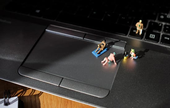 Work life balance - small vacation goers enjoying the afternoon sun on a laptop photo