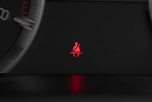 Seat belt warning light on car dashboard. Safety restraint law, safety concept. photo