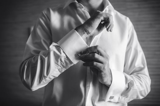 Groom prepares for wedding photo
