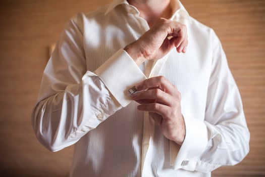 Groom prepares for wedding photo