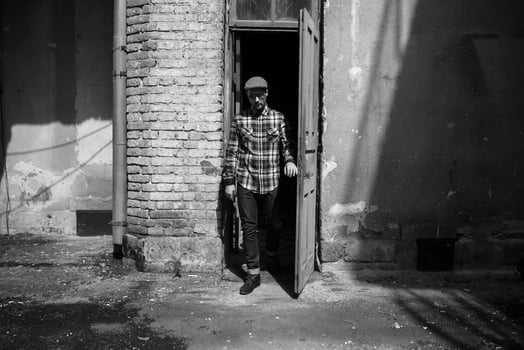 The man in the authentic boots and selvedge jeans  on a background of old city photo