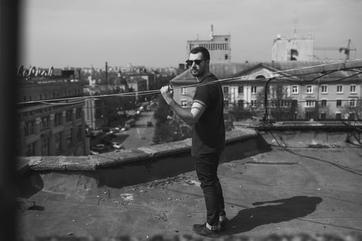 The man in the authentic boots and jeans selvedge on the roof of the building in the old town photo