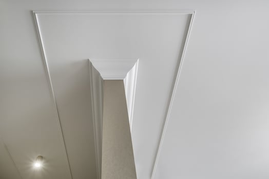 corner of ceiling cornice with intricate crown molding. photo