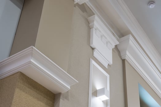 Detail of corner ceiling with intricate crown molding on column with spot light photo
