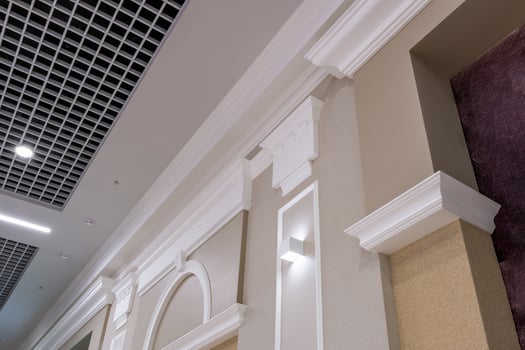 Detail of corner ceiling with intricate crown molding on column with spot light photo