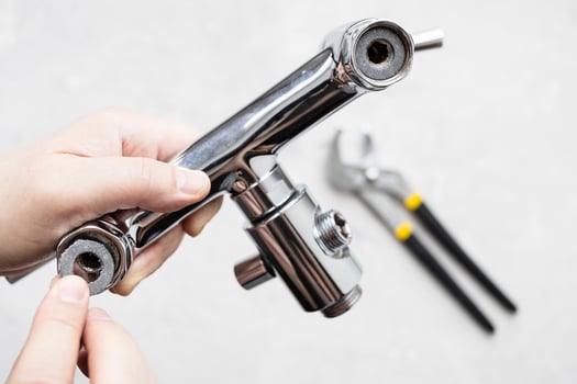 paronite gasket in faucet and adjustable wrench photo