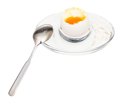 open soft-boiled white egg and spoon in egg cup photo