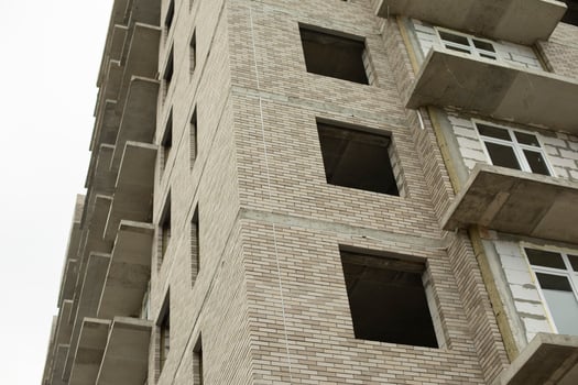 Windows of the house under construction. Construction of a building in the city. Construction of an apartment building. The building is unlined. photo