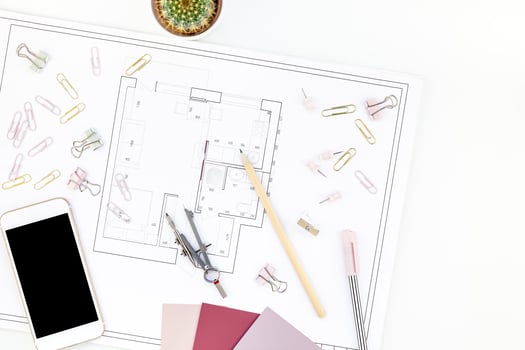 Interior designer table workplace with house plan photo