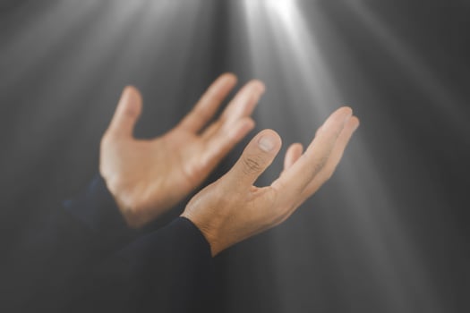 Hand folded prayer to god on dark in church concept for faith, spirituality and religion, woman person praying on holy bible in morning. Christian catholic woman hand with worship in black background. photo