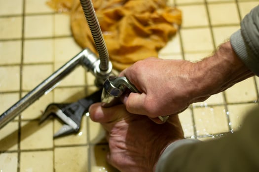 Repair of plumbing. Plumber repairs the faucet in Russia. photo