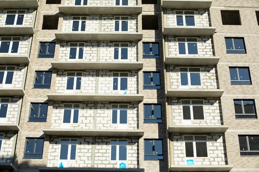 New building. Construction of an apartment building in Moscow. Residential house in sunlight. Inserted plastic windows in the house. photo