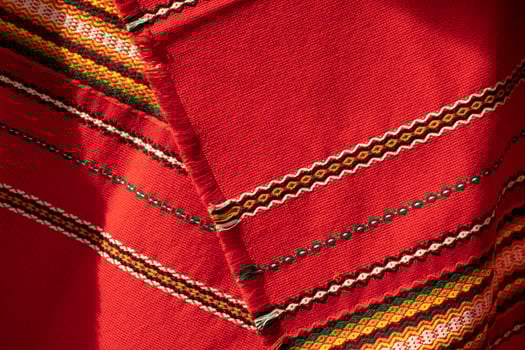Red tablecloth in Russia. Folk pattern on the fabric. Fabric material in the Slavic peoples. photo