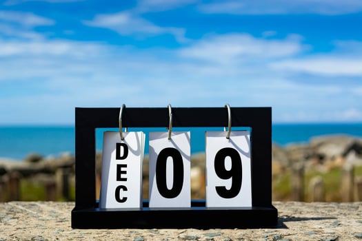 Dec 09 calendar date text on wooden frame with blurred background of ocean. photo