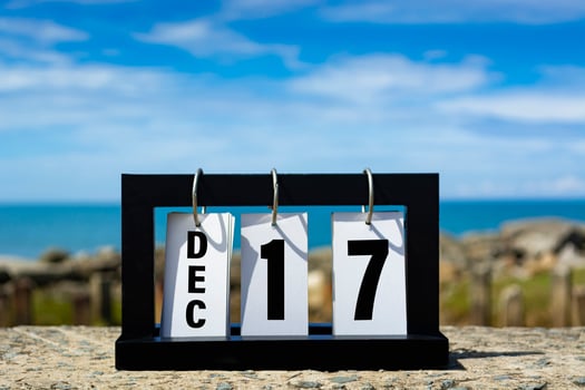 Dec 17 calendar date text on wooden frame with blurred background of ocean. photo