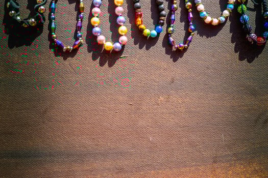 Heap of colored bright jewelry beads on a dark background. Different gems beads necklace. Jewel necklace modern fashion pattern or texture. copy space. photo